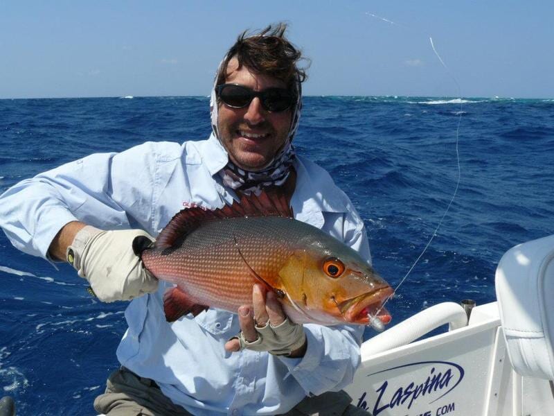 Man carrying fish 2 — Dean Jackson Guided Tours in Winnellie, NT