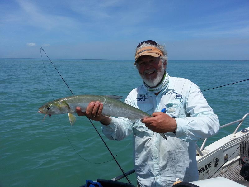 Man carrying fish 6 — Dean Jackson Guided Tours in Winnellie, NT