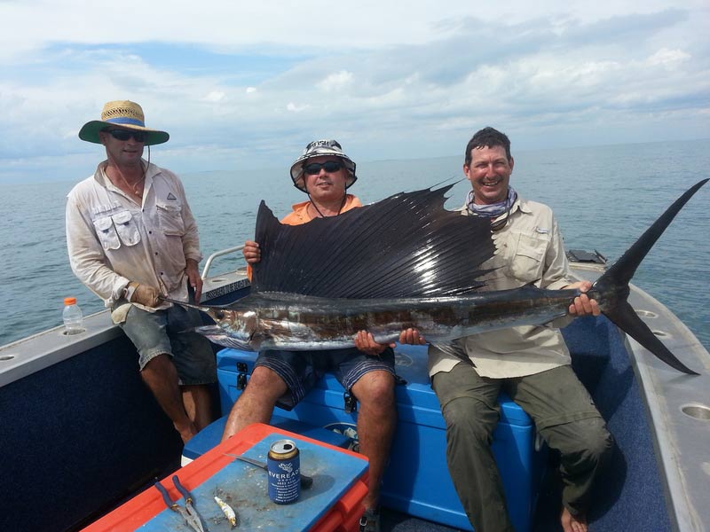 Three men carrying their big sword fish 2 — Dean Jackson Guided Tours in Winnellie, NT