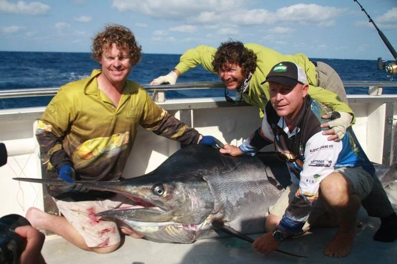 Three men catch a big sword fish — Dean Jackson Guided Tours in Winnellie, NT