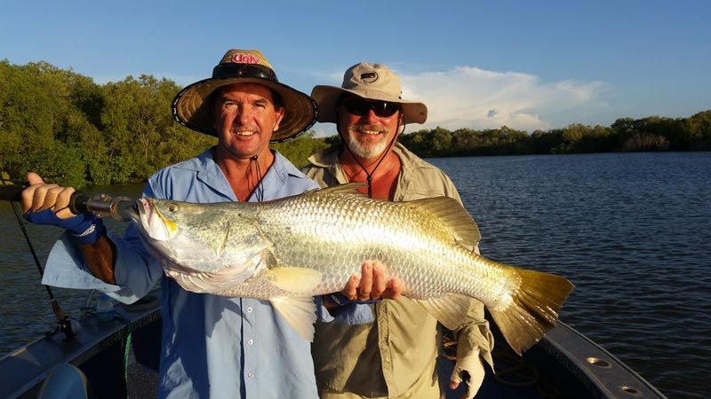 Two men carrying bigger fish 3 — Dean Jackson Guided Tours in Winnellie, NT