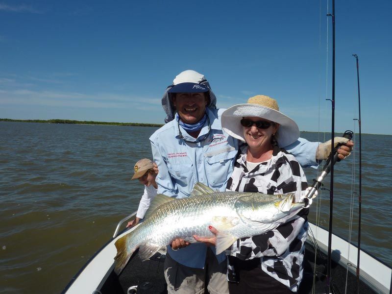 Two men carrying bigger fish 4 — Dean Jackson Guided Tours in Winnellie, NT
