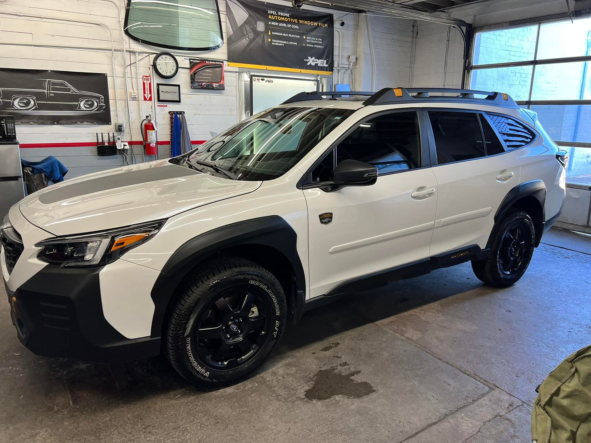 A white suv is parked in a garage.