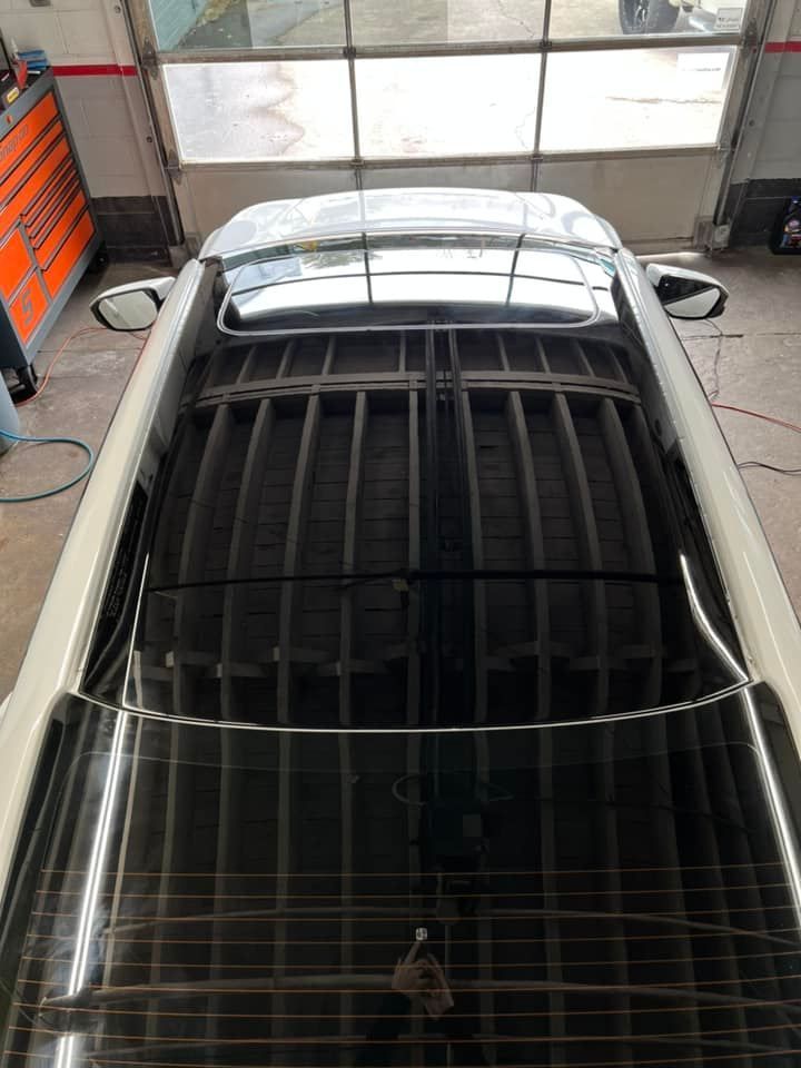 The roof of a car is visible in a garage.