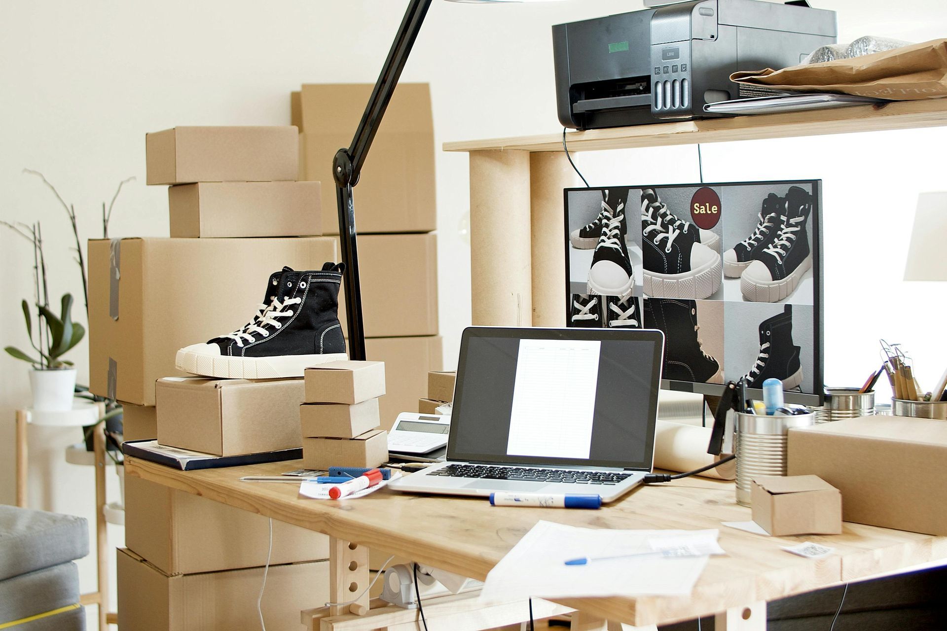 A desk with a laptop and boxes on it
