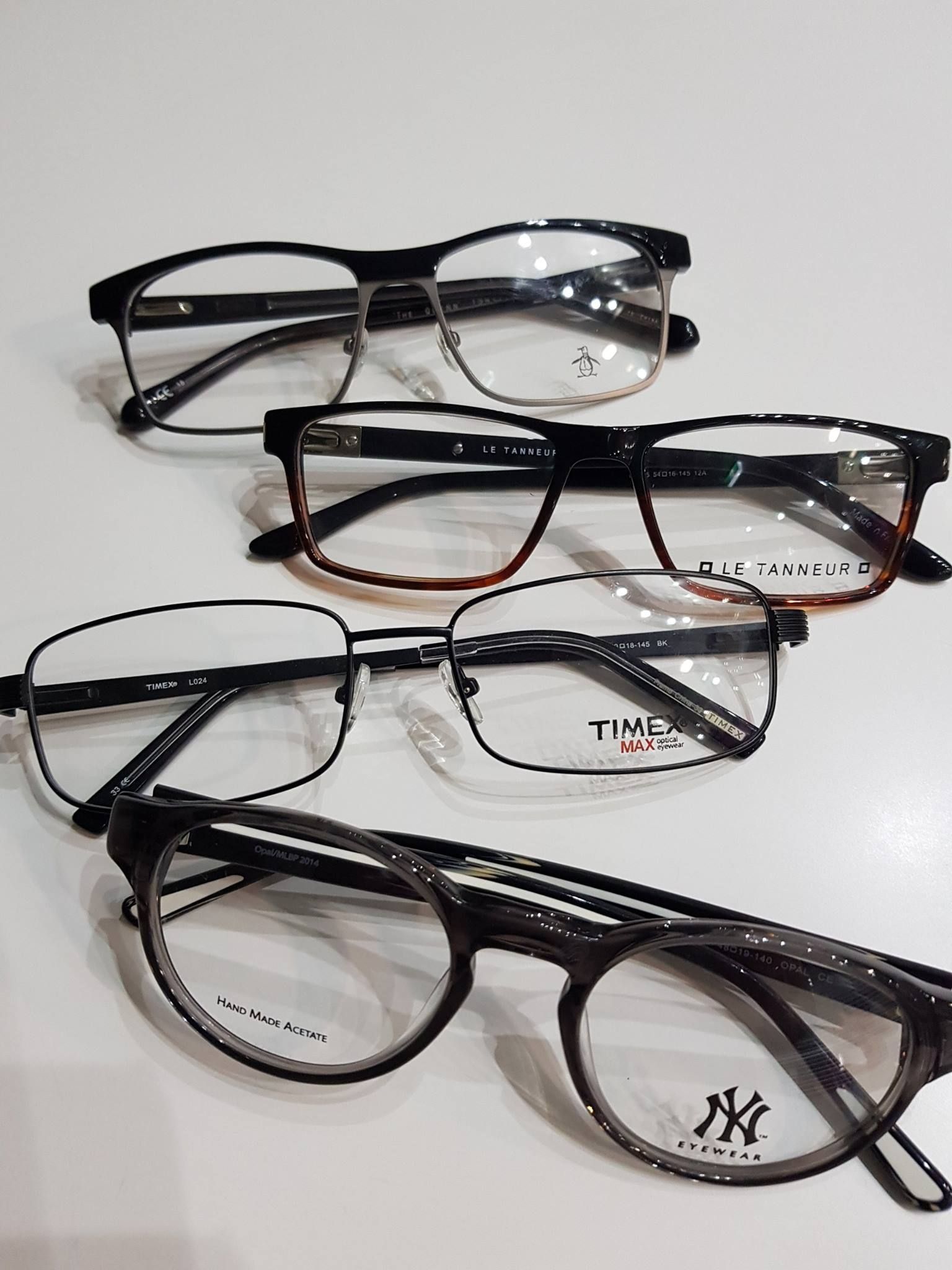 A Group of Glasses Are Sitting on Top of Each Other on a Table — Ian Emslie Optometrist In Warners Bay, NSW