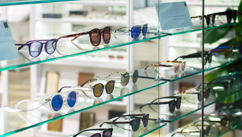 A Display Case Filled With Sunglasses and Glasses in an Optical Shop — Ian Emslie Optometrist In Warners Bay, NSW