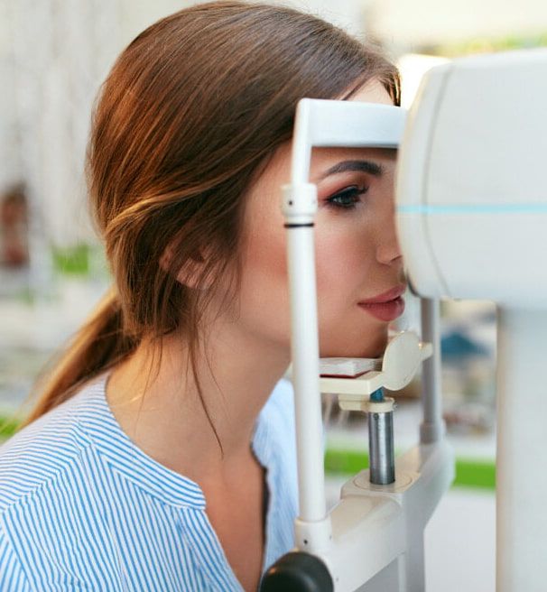 A Woman is Getting Her Eyes Examined by an Ophthalmologist — Ian Emslie Optometrist In Warners Bay, NSW