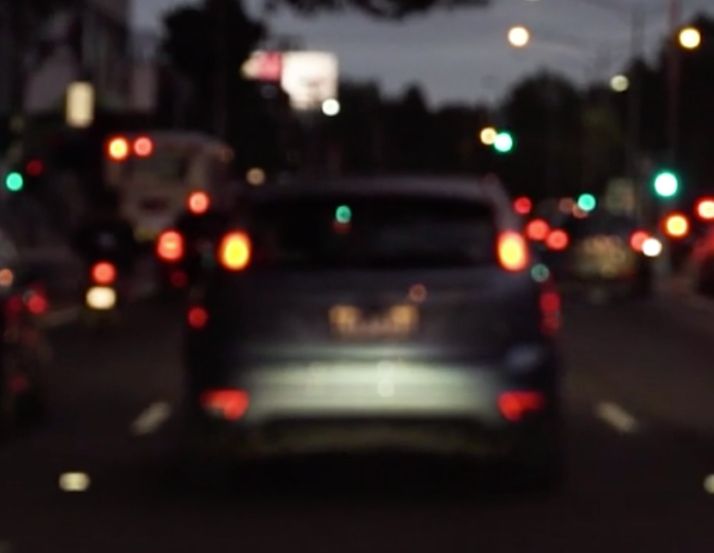 A Blurry Picture of a Car Driving Down a Street at Night — Ian Emslie Optometrist In Warners Bay, NSW