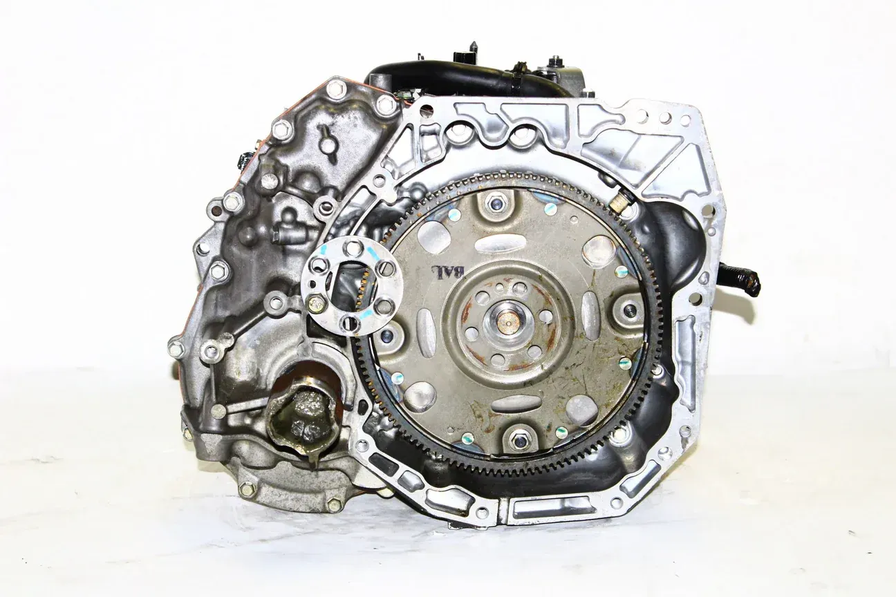 A clean, silver-colored automotive transmission component viewed from the side against a white background.