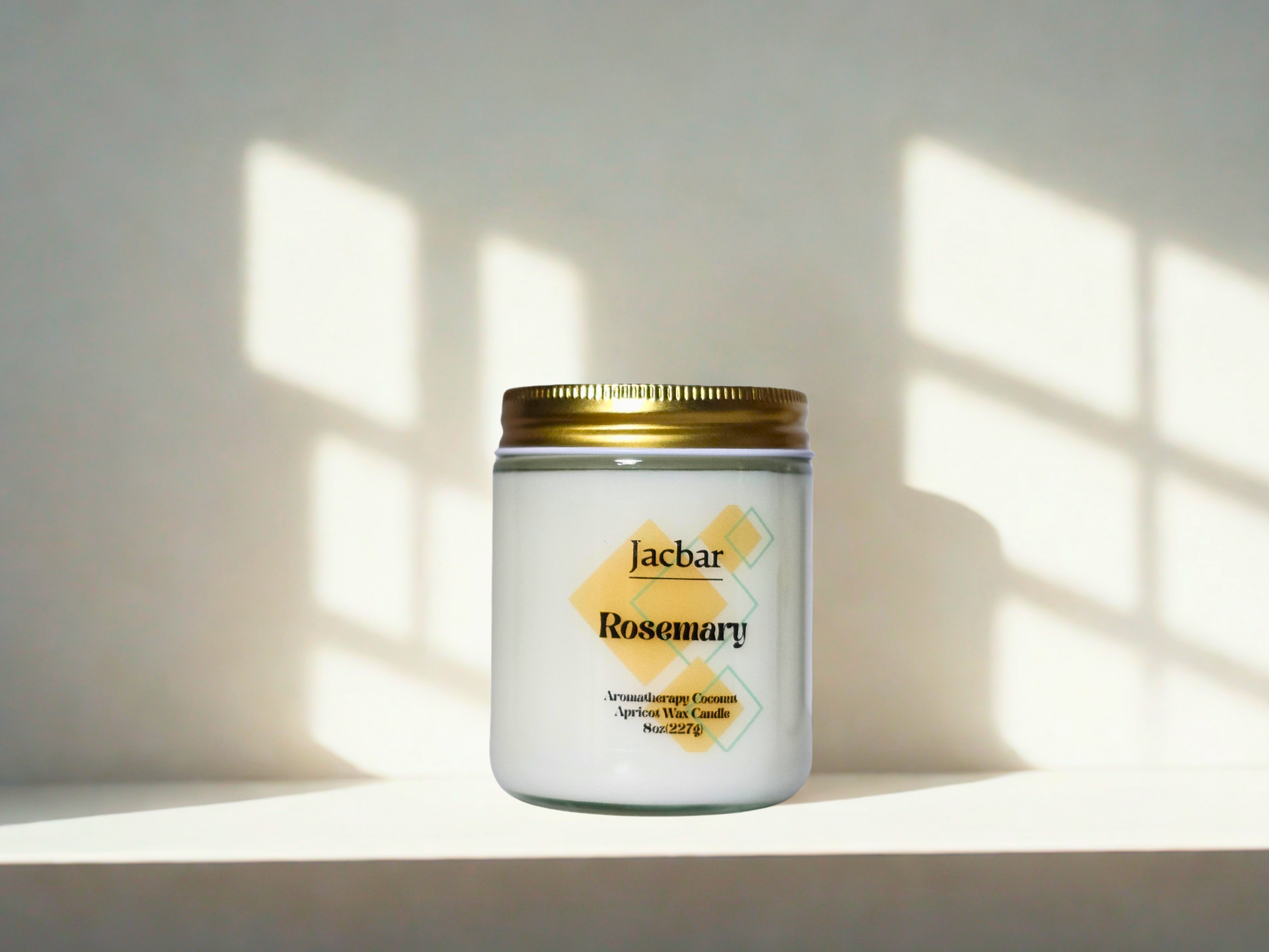 White jar candle with a gold lid, labeled 