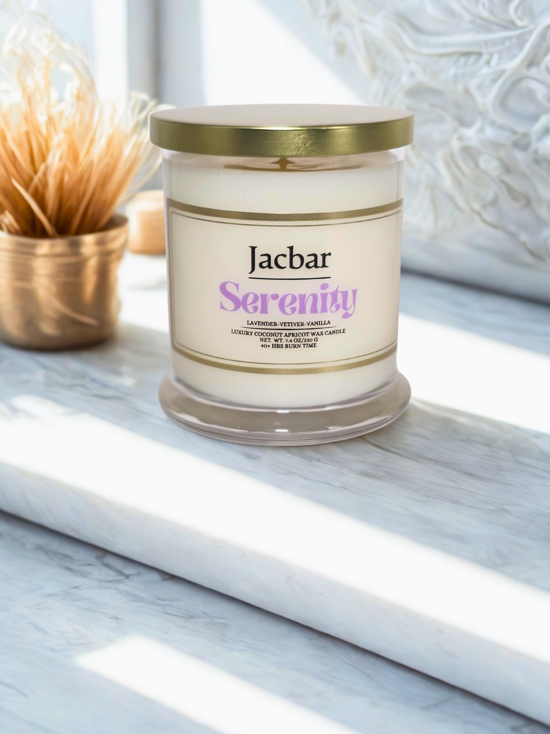 Candle in a jar with gold lid, labeled 