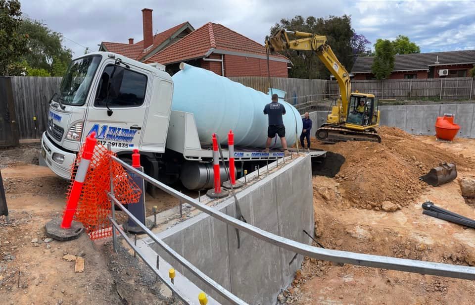 A truck is sitting on top of a concrete wall at a construction site.