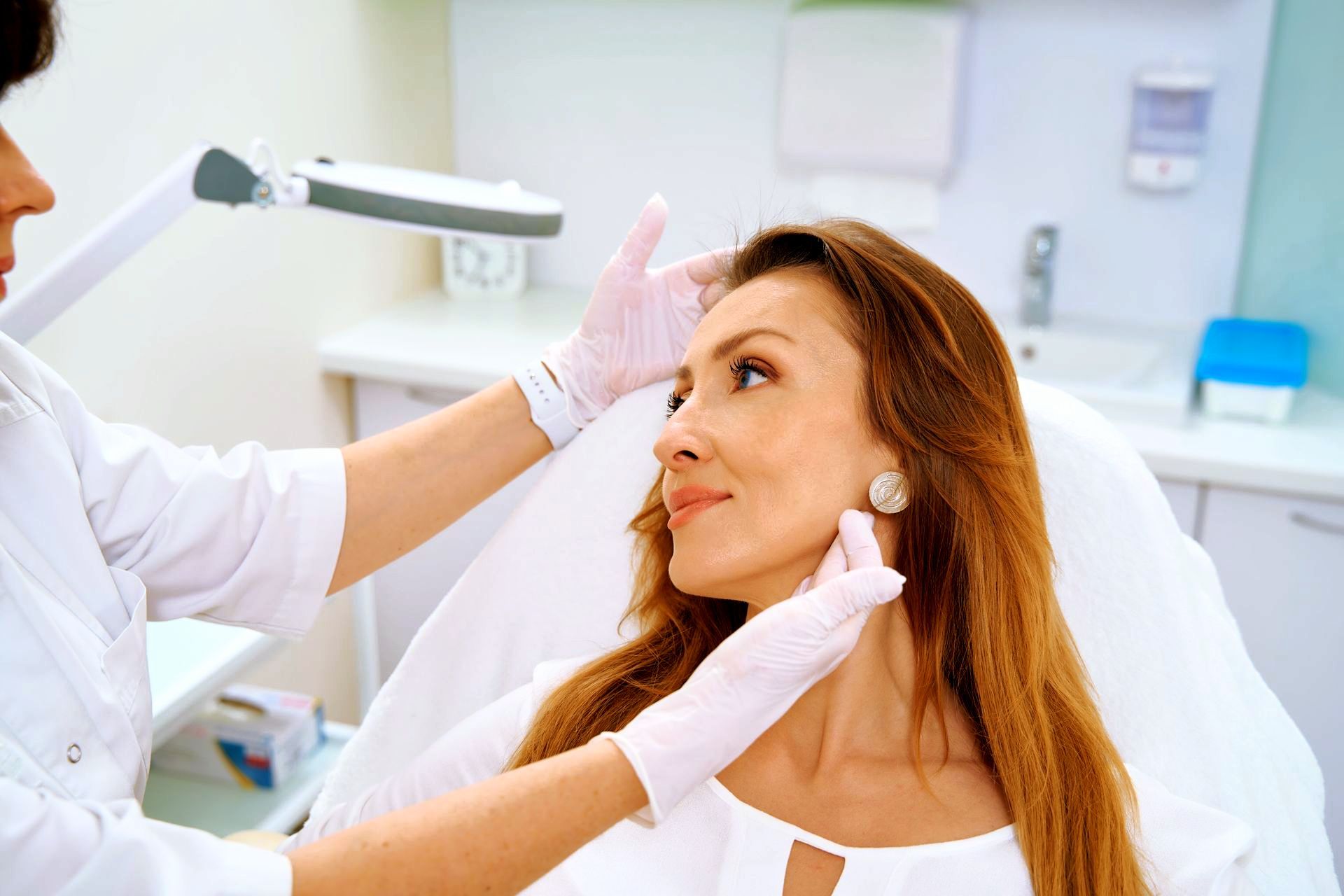woman filing at dentist | botox and facial fillers in hunt valley md