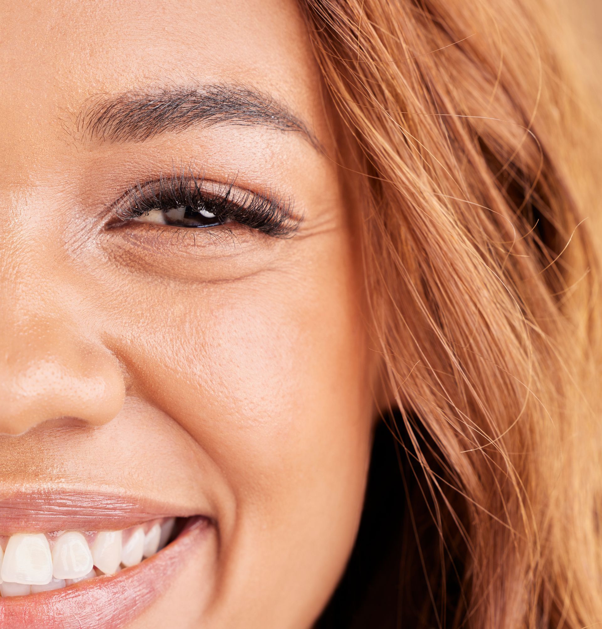 A close up of a woman 's face with a smile on her face.