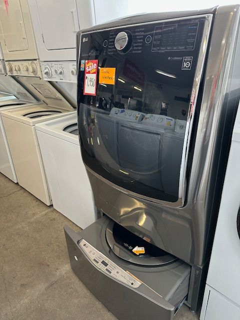 A washer and dryer are sitting next to each other in a laundromat.