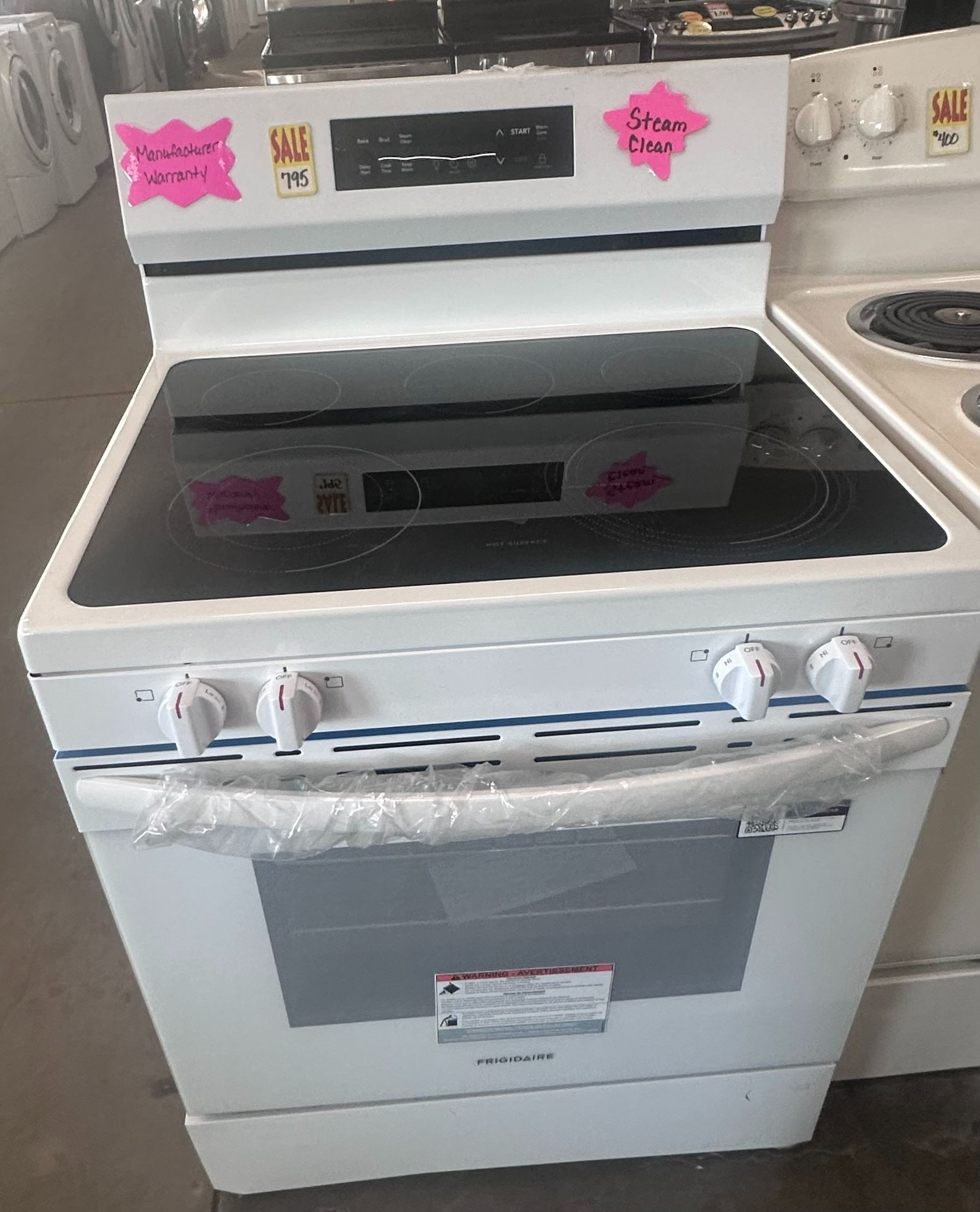 White electric range with black cooktop and oven door.