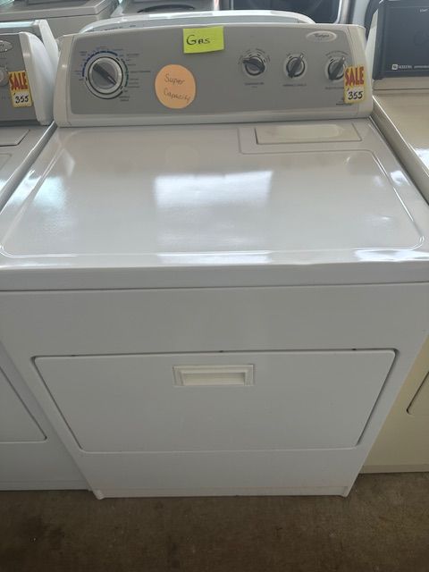 A white washer and dryer with a yellow sticker that says sale on it
