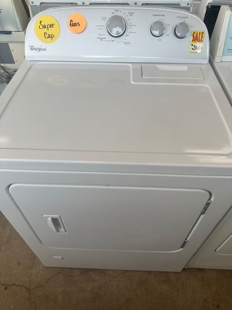 A white dryer with a yellow sticker that says super tap