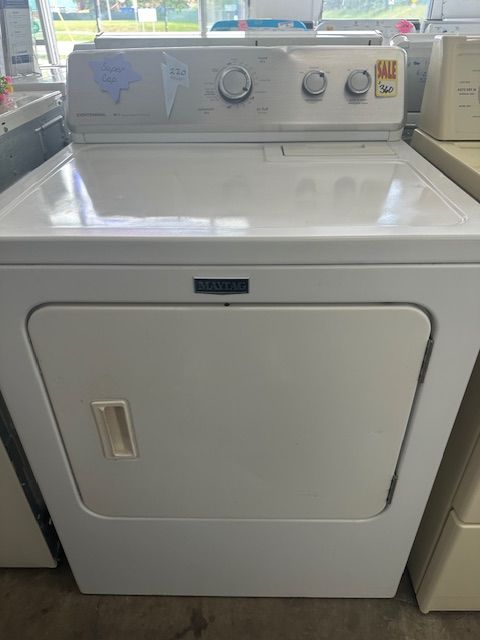 A white dryer is sitting on top of a counter in a store.
