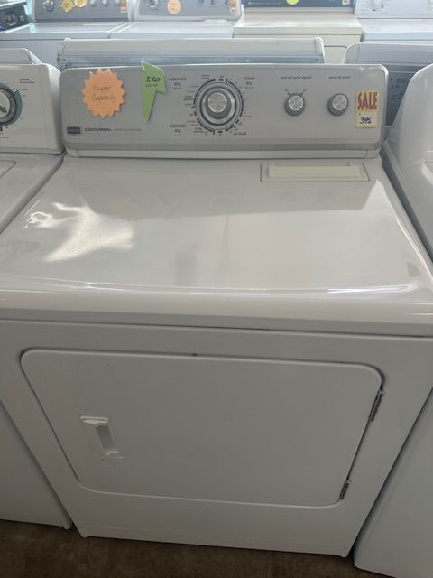 A white washer and dryer are sitting next to each other on a counter.