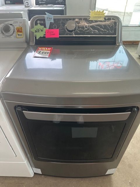 A stainless steel stove top oven is for sale in a store.