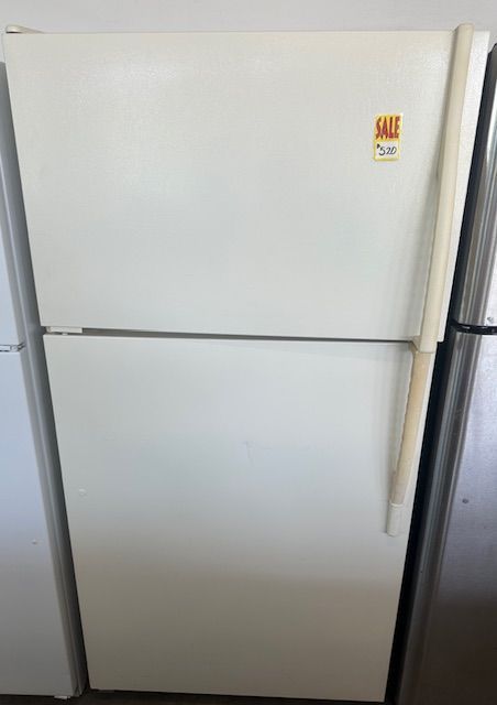 A white refrigerator with a sale sticker on the door.
