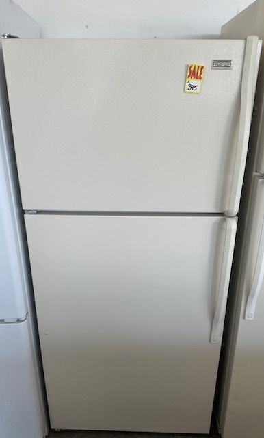 A white refrigerator with a sale sticker on the door.
