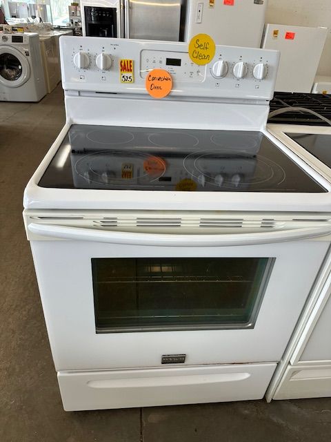 A white stove top oven with a price tag on it