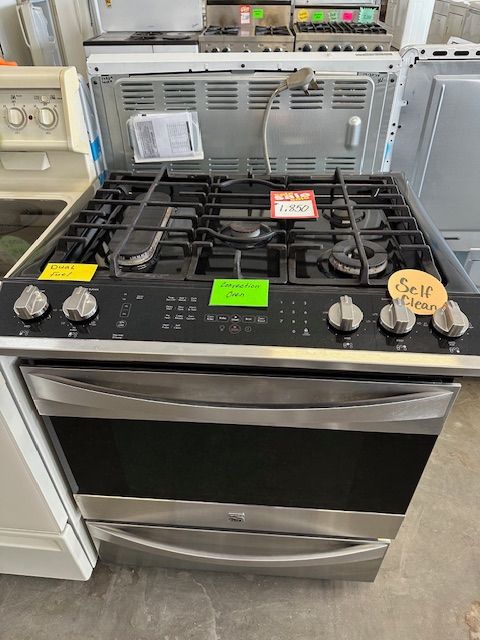 A gas stove with a sign that says sell on it