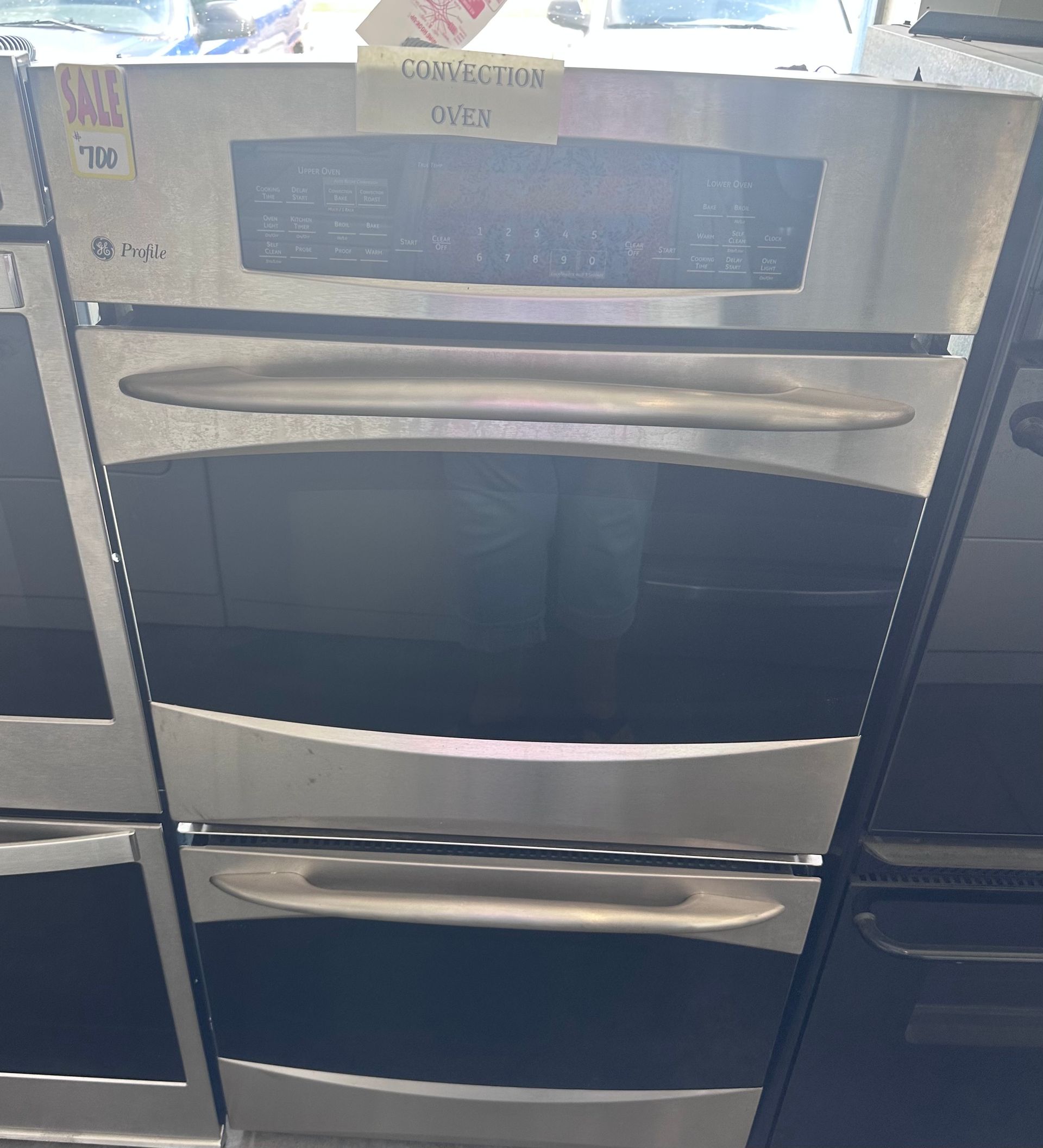 Stainless steel double oven with dark glass doors and control panel.