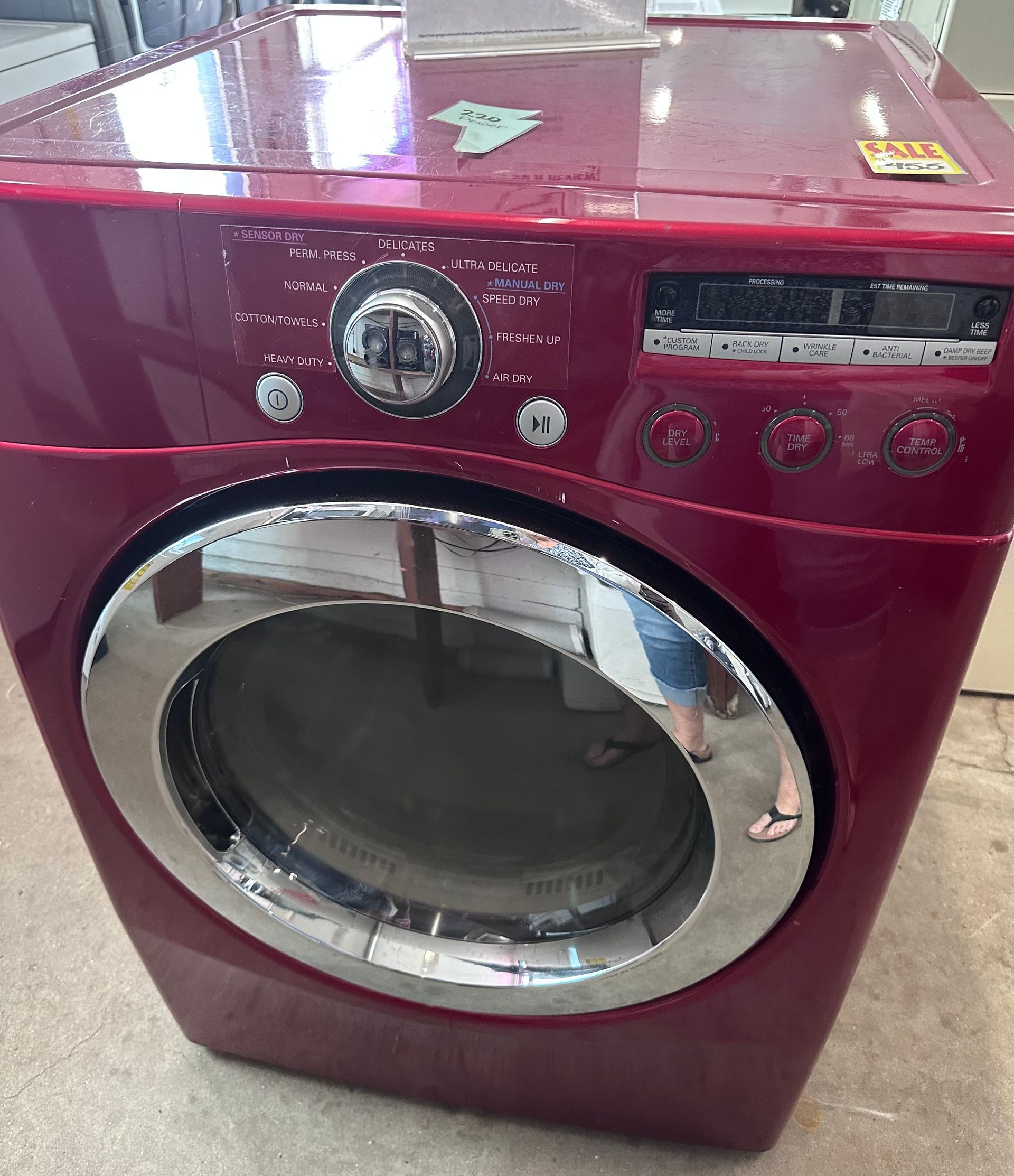 A red lg washer and dryer is sitting on the floor