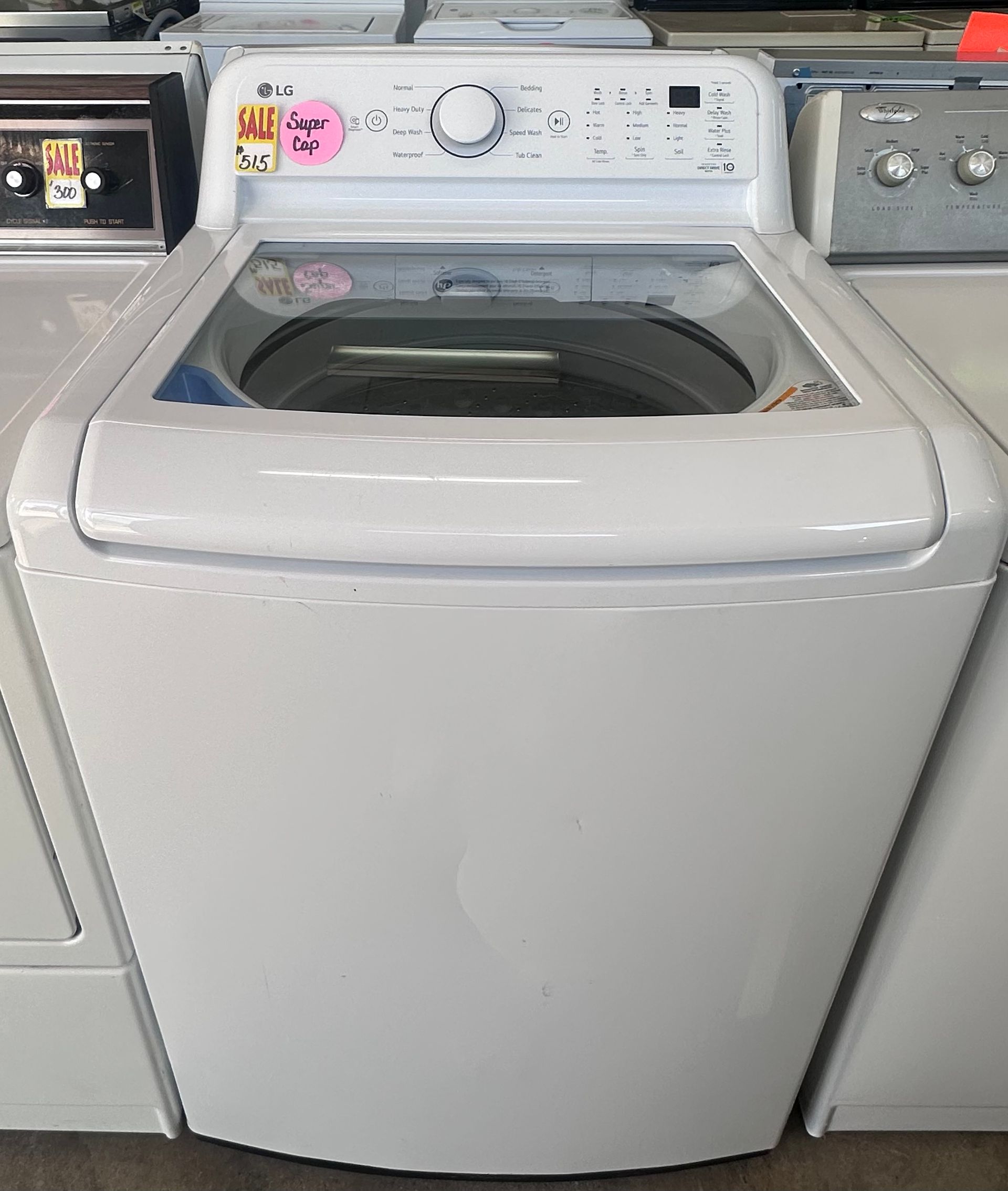 A stainless steel washing machine with a black door
