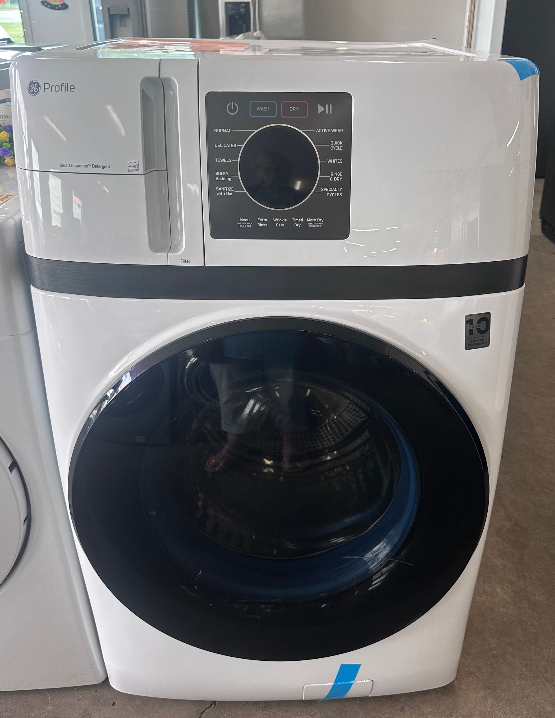 White LG washing machine with black door and control panel, possibly new.