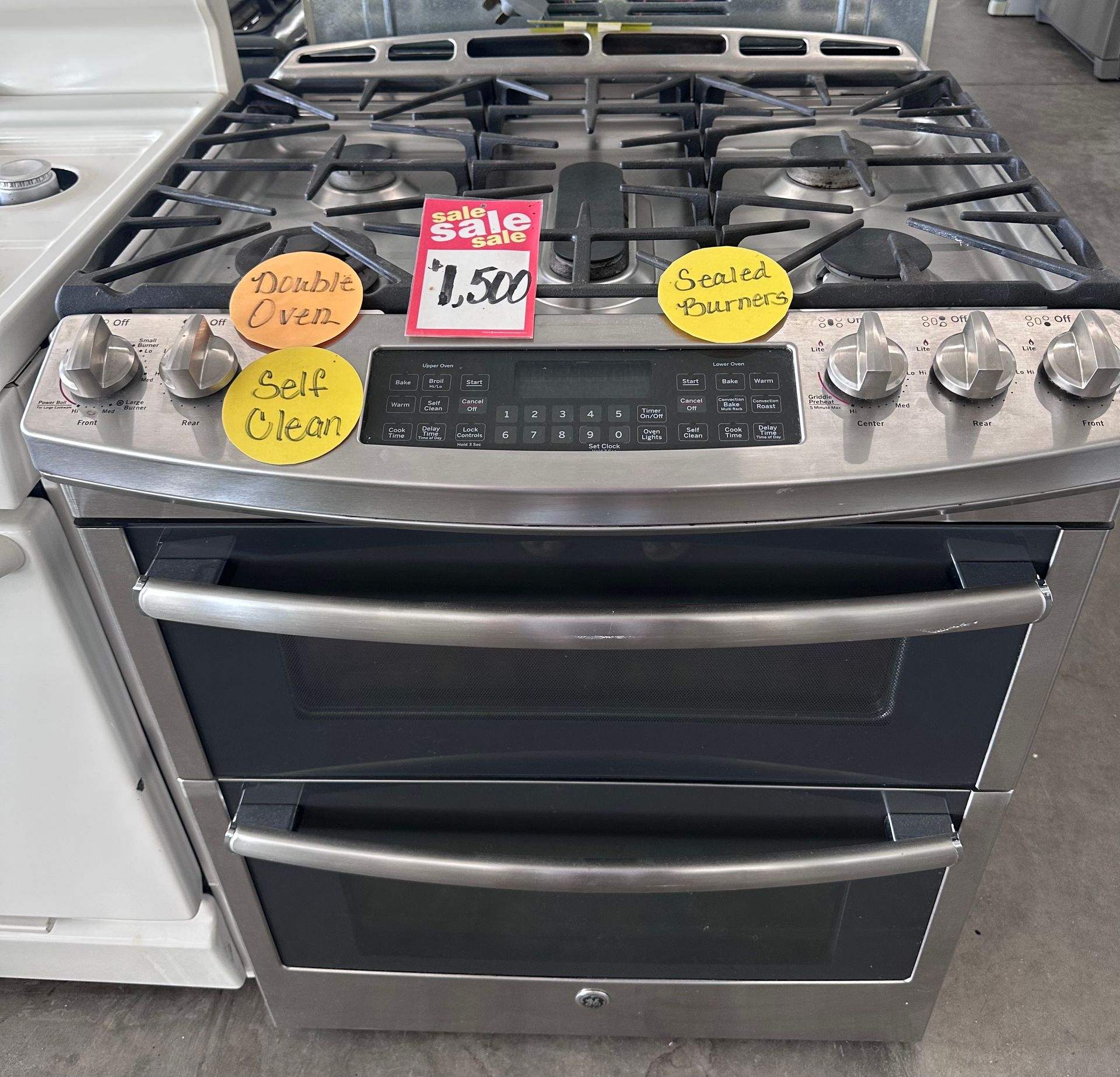 Stainless steel GE gas range with a double oven, on sale for $1,500.