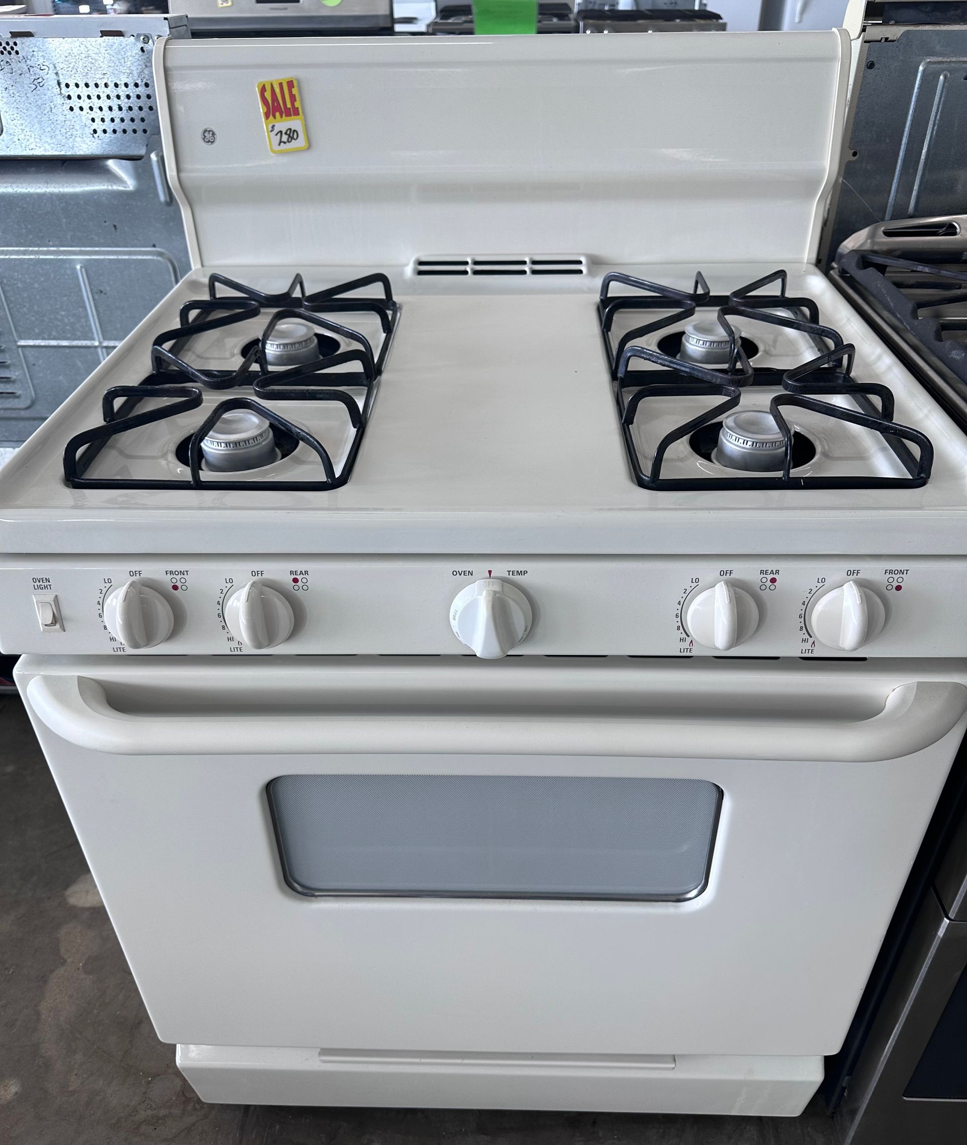 White gas range with four burners and an oven.