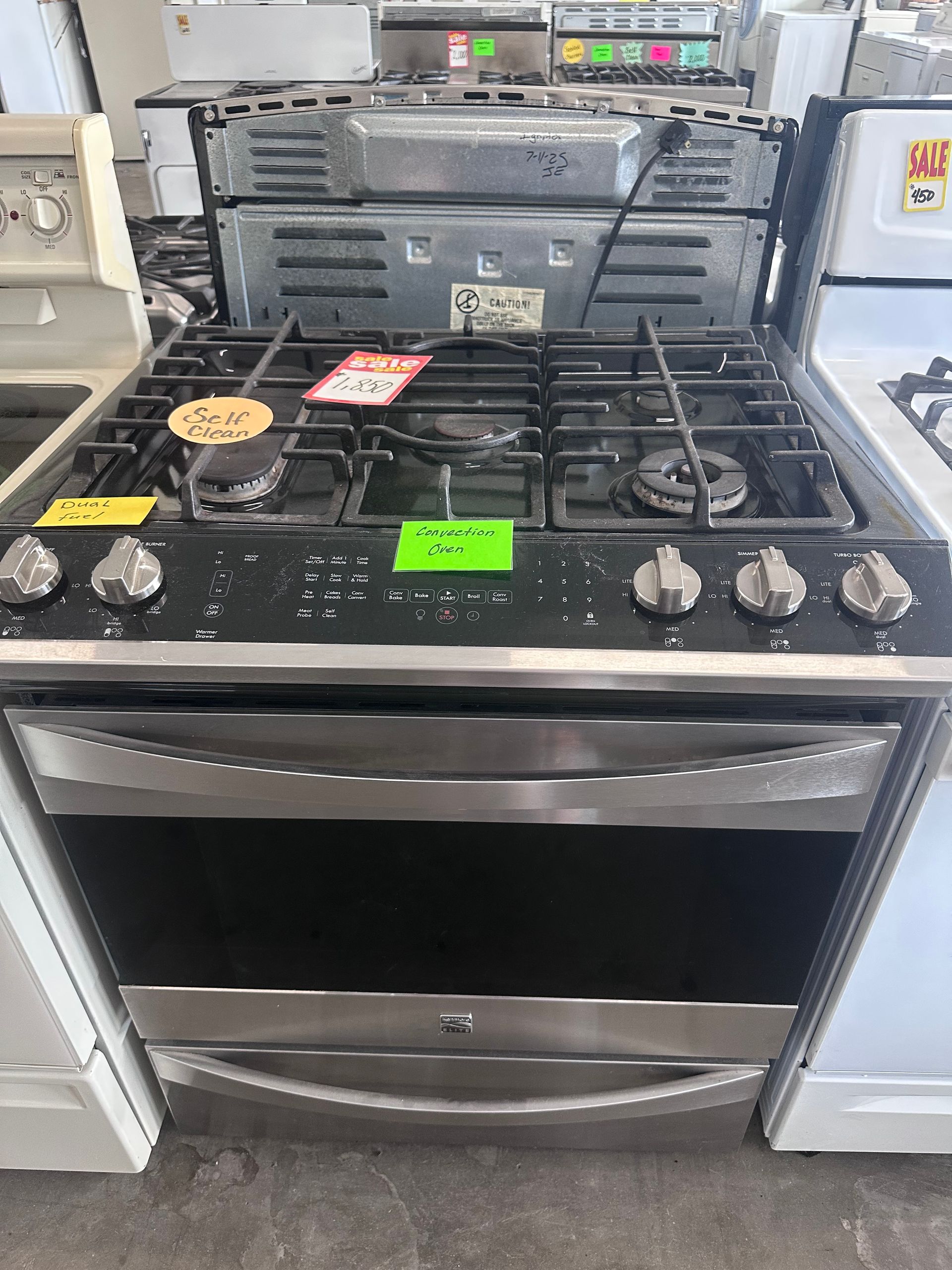 A stove with a price tag on it is sitting in a store.