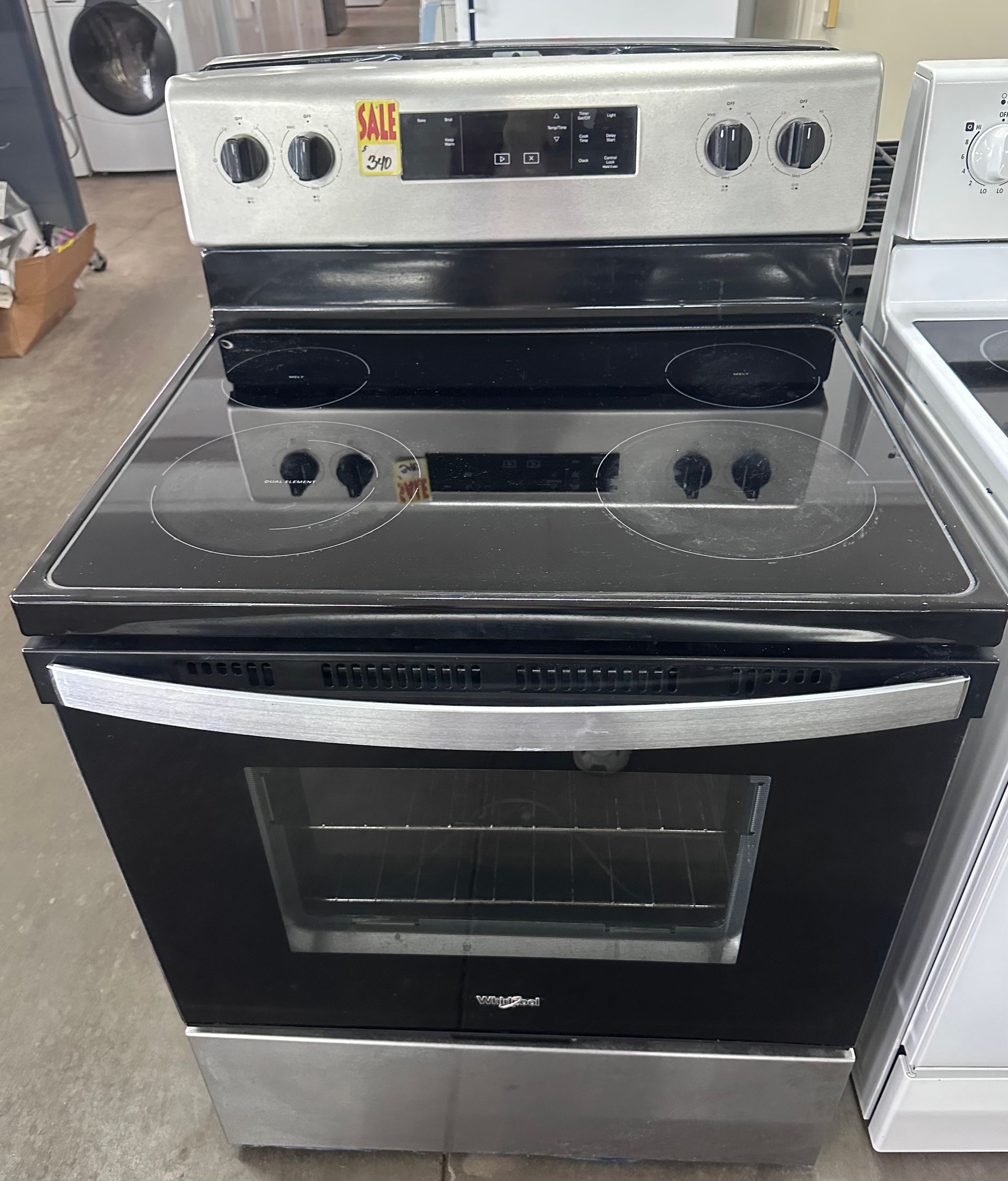 Black and stainless steel electric range with oven in a kitchen display area