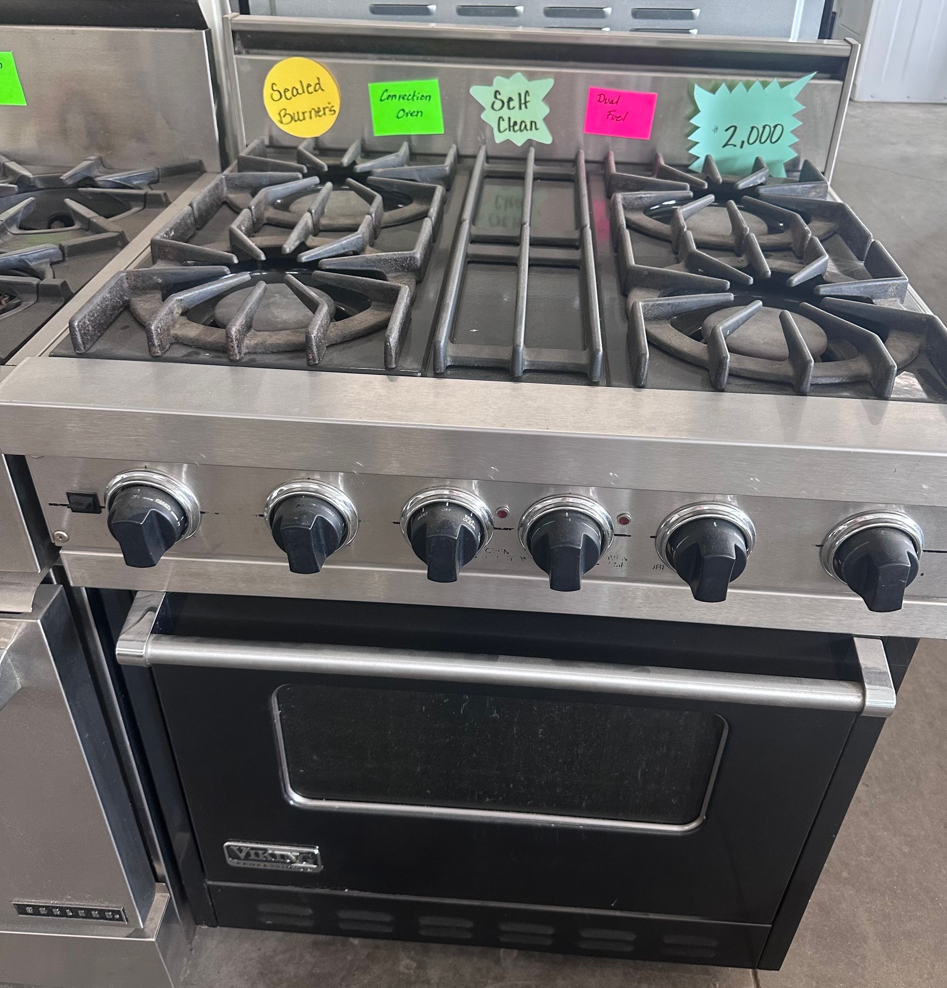 A stove with stickers on it including one that says beef rack