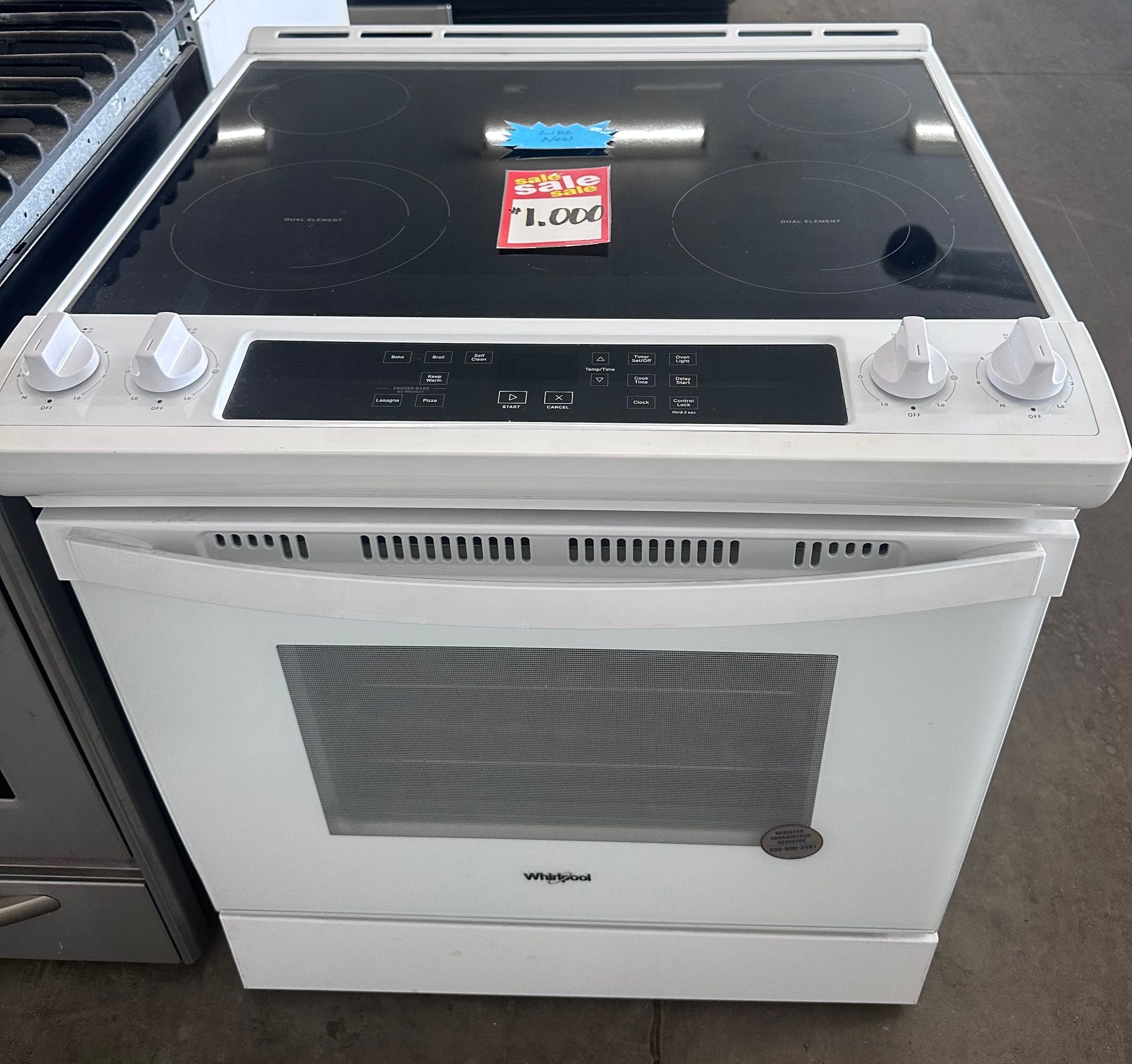 A white stove with a sticker that says 