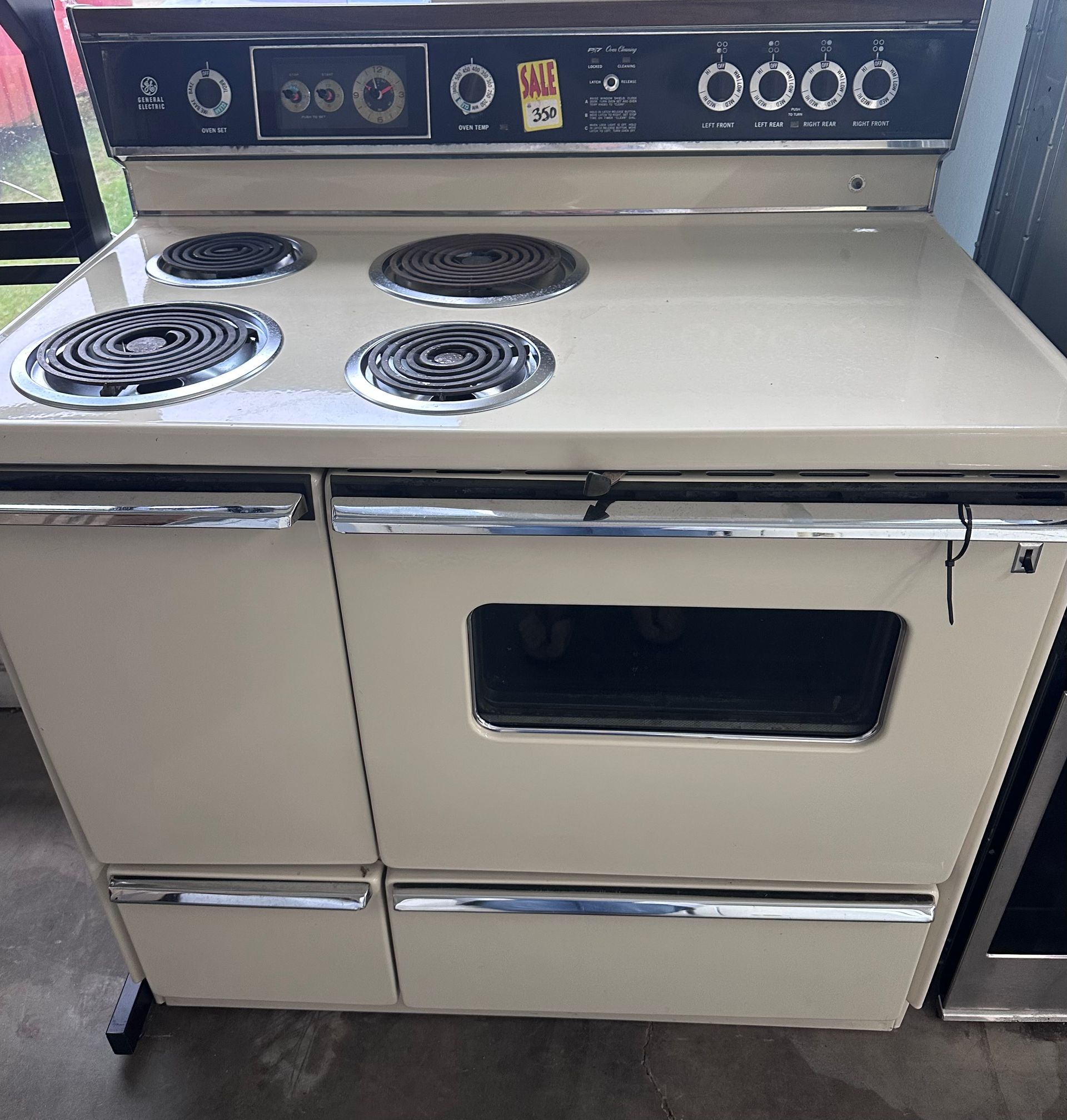 A white stove with a few buttons on it