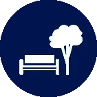 A white icon of a bench and a tree in a blue circle.