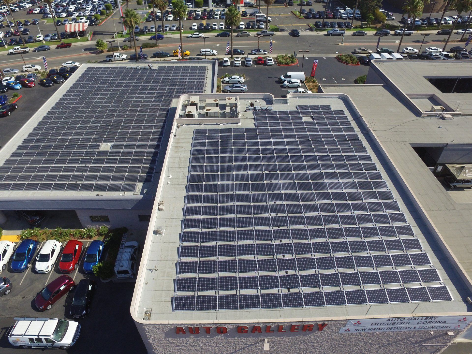 An aerial view of a building with solar panels on the roof