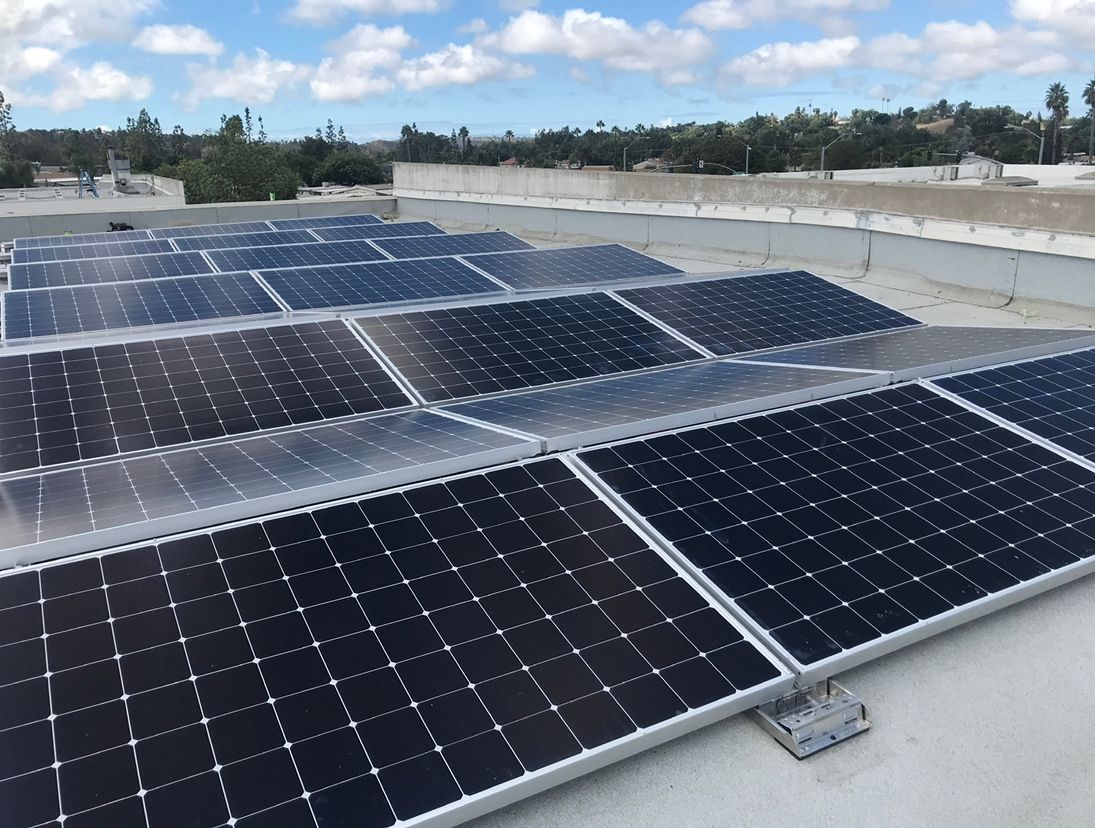 A row of solar panels on top of a roof