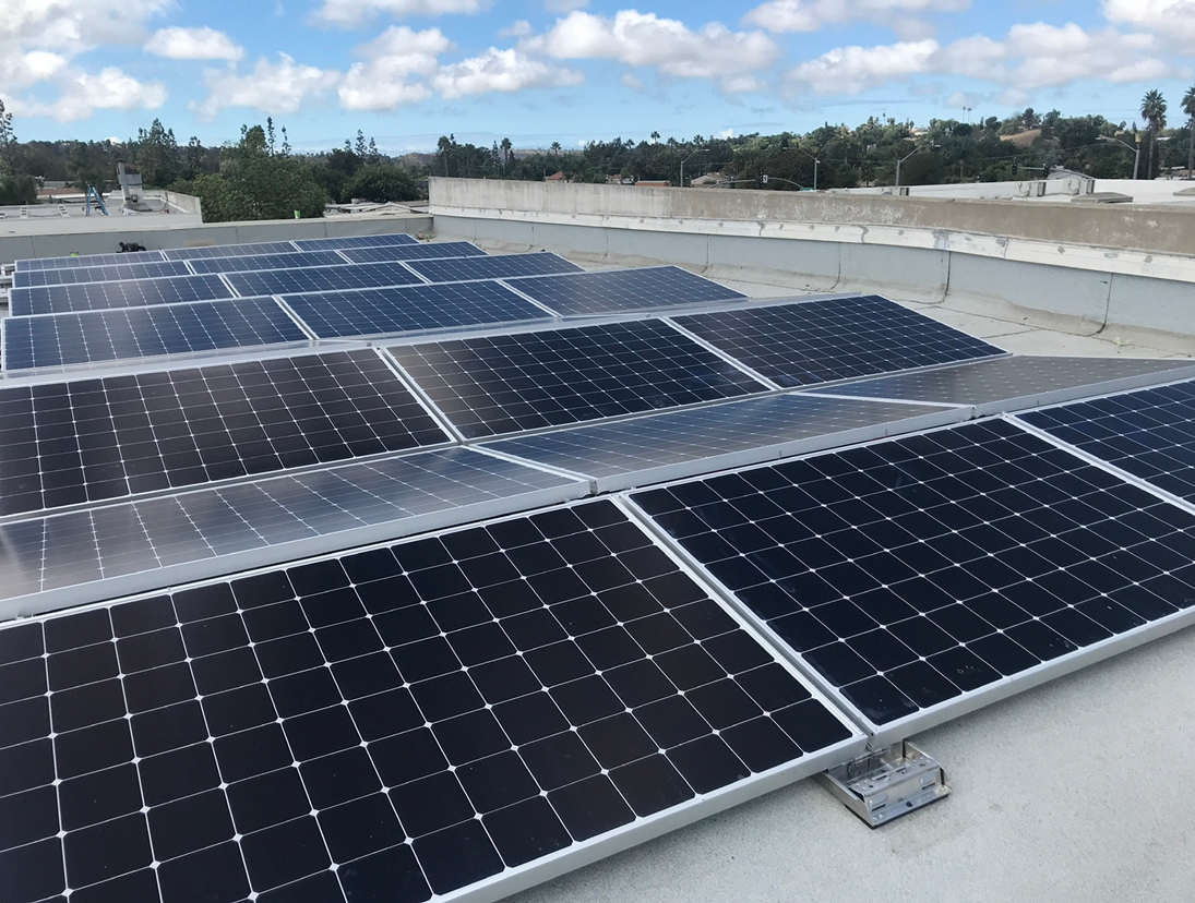 A row of solar panels on top of a roof
