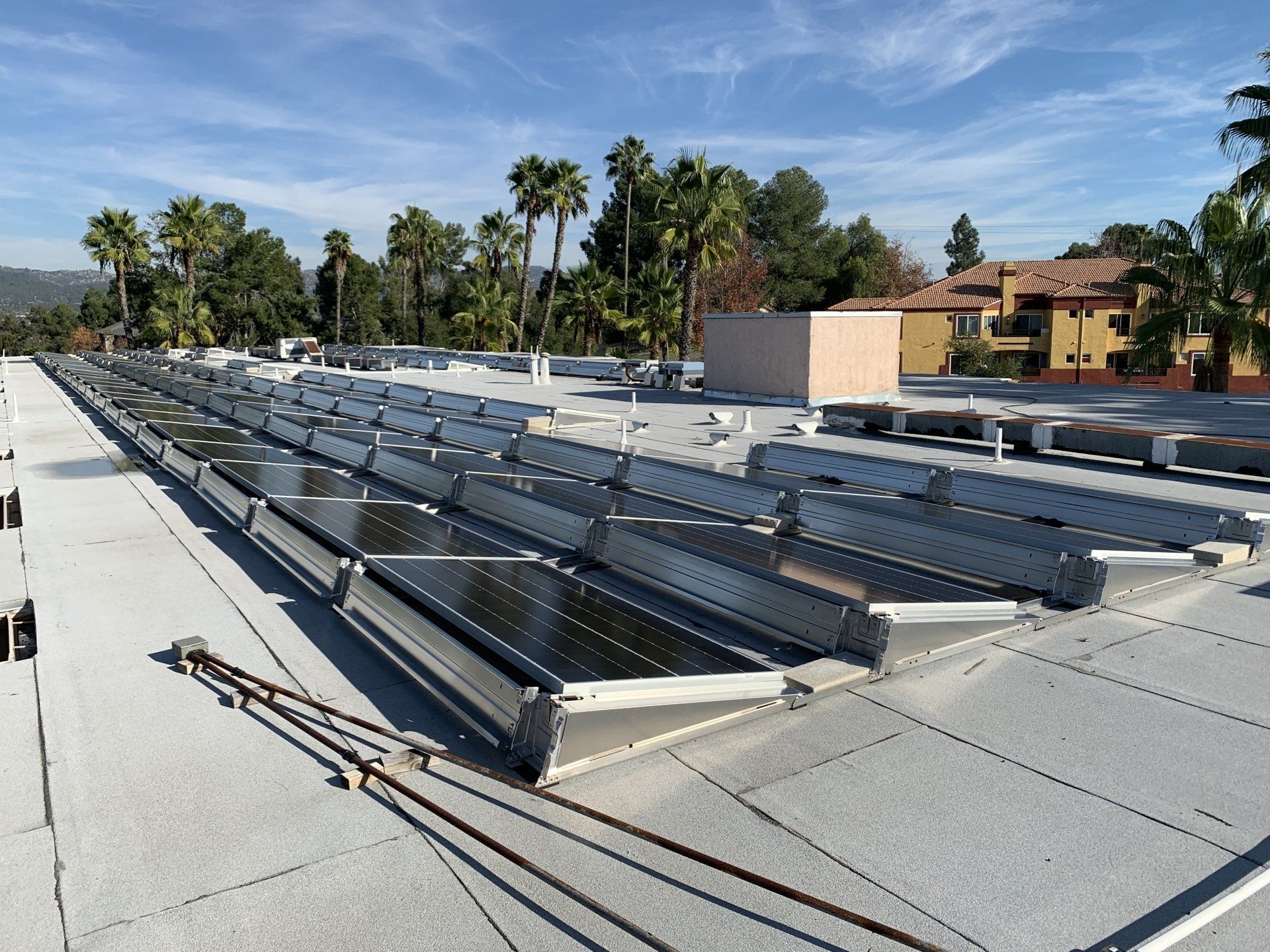 A row of solar panels on the roof of a building