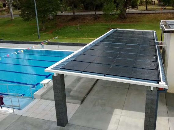 A swimming pool with a solar panel on the roof