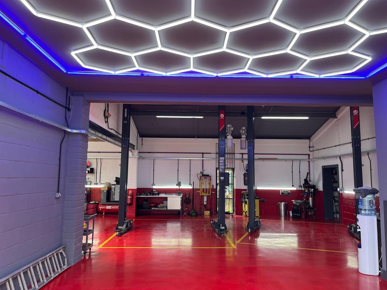A garage with a honeycomb ceiling and a ladder.
