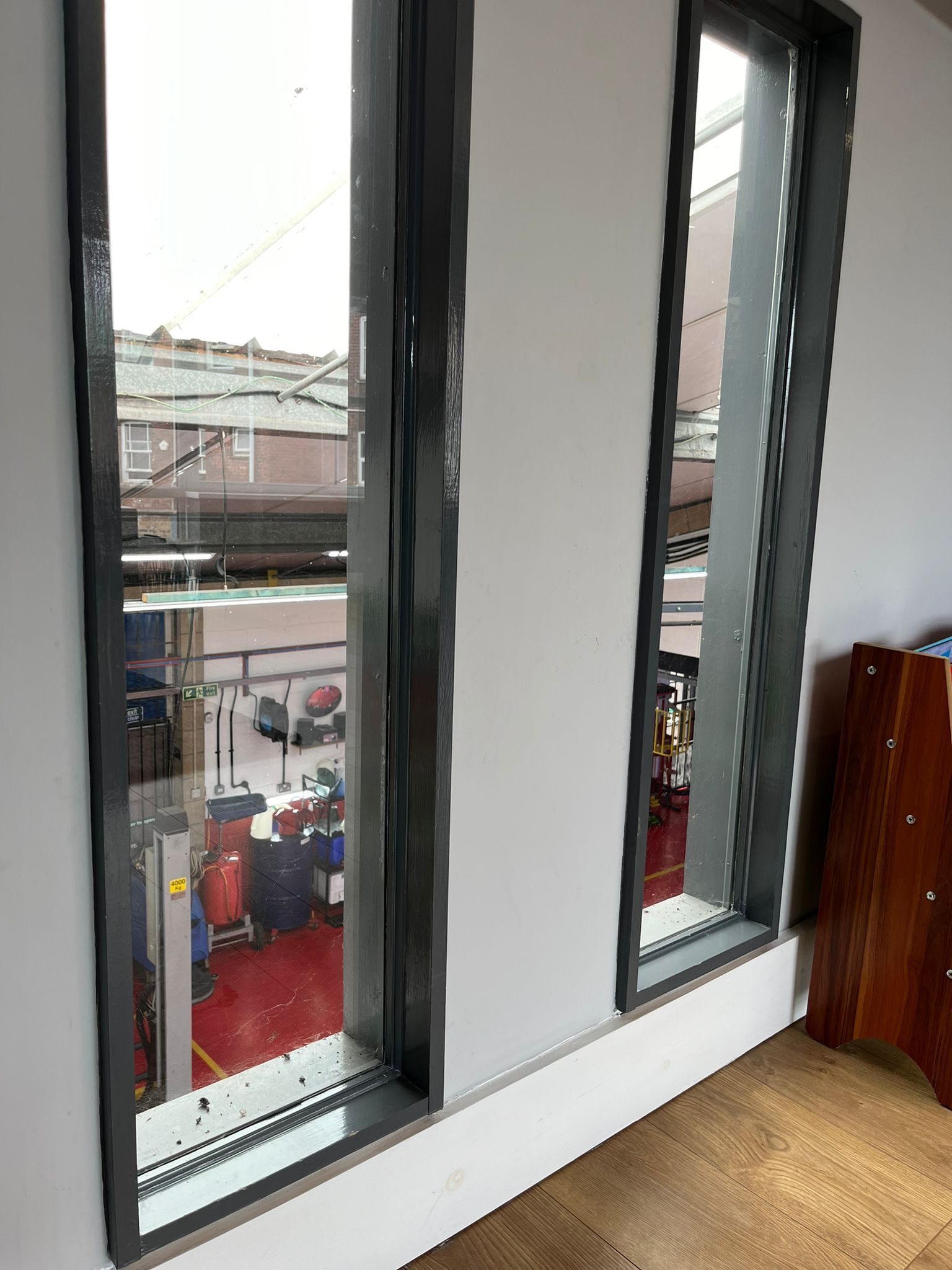 A room with a lot of windows and a view of a building.