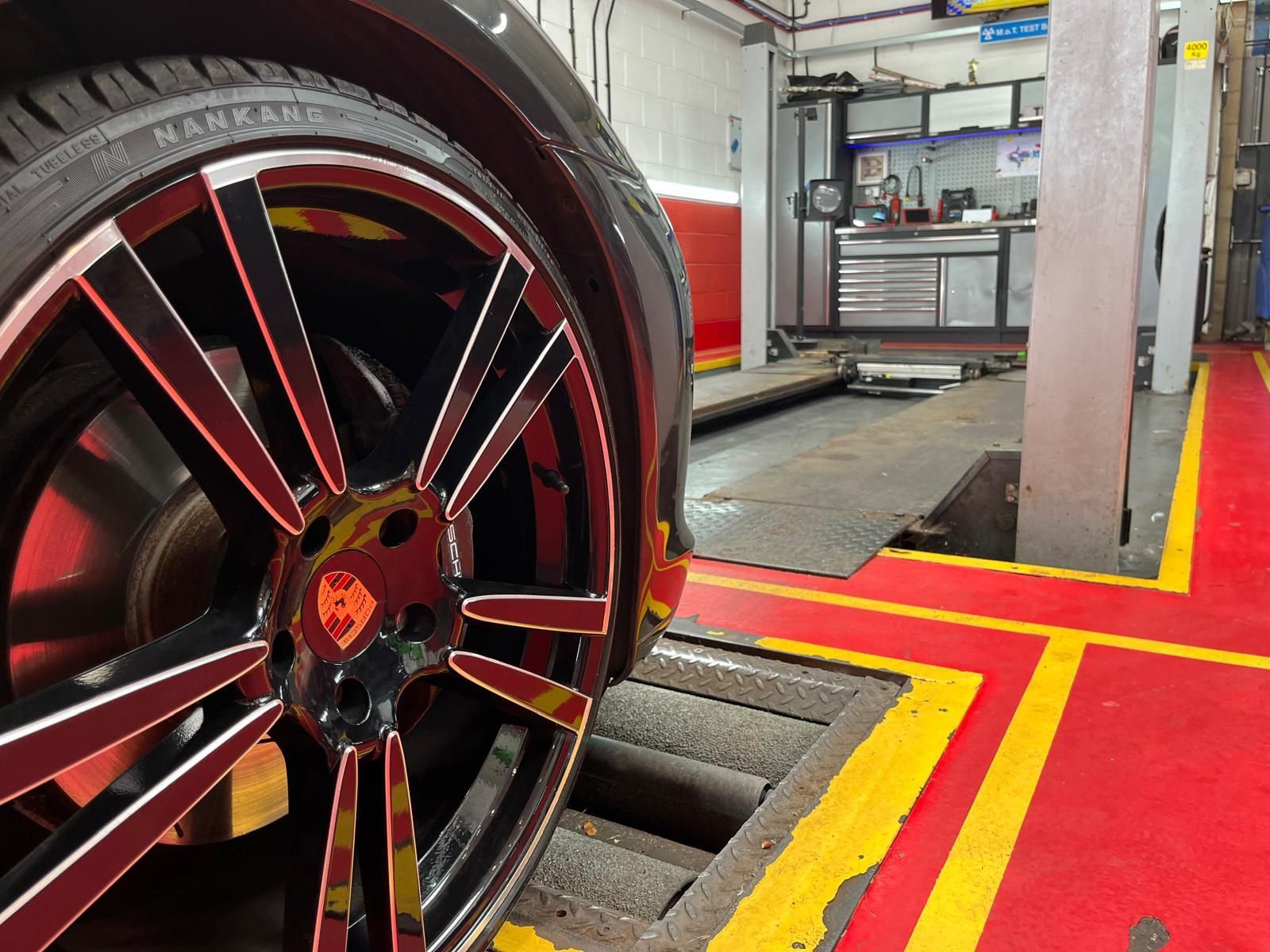 A close up of a car wheel in a garage